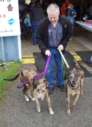 Dr. Michael Ramieri of Franklin&#xfe;&#xc4;&#xf4;s Advanced Veterinary Care is shown taking a break as he takes his two adopted Catahoula Leopard Dogs, Simon and Jasmine, out for a much needed breath of air.