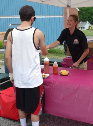 Lori Fitamant helped to man the tent with tasty victuals from Smokey&#xfe;&#xc4;&#xf4;s Brick Oven Tavern.