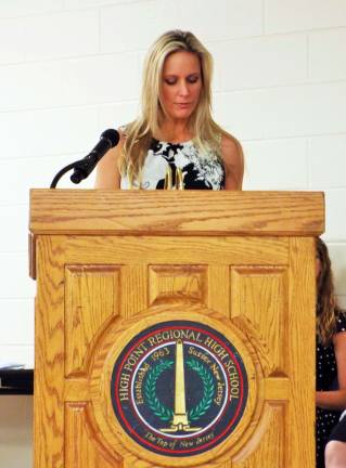 Fine Arts teacher Erin Meyers introduces the National Honor Society charge to new members which begins,&quot;Take care of the world, its colors and forms...&quot;