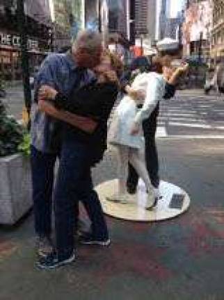 Fred and Renee Zierold of Franklin, share a kiss in front of a statue of Alfred Eisenstaedt's famous photo &quot;The Kissing Sailor&quot;.