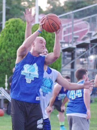 Team Tobin's Mike Tobin snatches the ball in midair during a rebound.