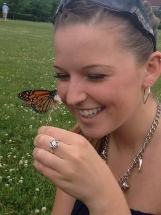 Butterfly Release Celebration guest, Erin Optiz welcomes a newly released butterfly at a previous Butterfly Release Celebration.