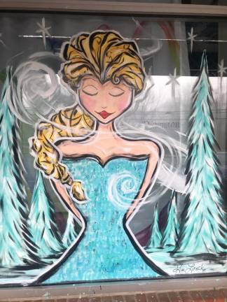 Artist celebrates decade of painting holiday spirit Kimberly Lonsky's artwork on the window of Dance Dimensions in Sparta.