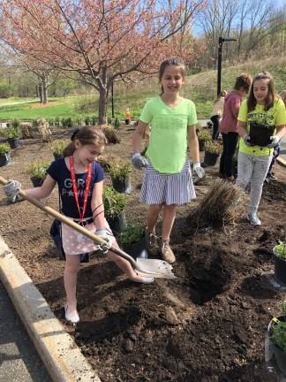 From left: Alexandra Friedman (3rd Grade), Jessica Moran (4th grade) and Lilyanna Klaver (2nd grade) plated perennials at Selective&#x2019;s headquarters in Branchville on April 25 as part of the company&#x2019;s Take Your Daughters and Sons to Work event. The activity was led by Farmside Landscape and Design who provided nearly 100 plants &#x2013; one for every child in attendance &#x2013;&#xa0; to take part in the Earth Day-themed planting. Selective&#x2019;s Take Your Daughters and Sons to Work Day event provided the kids a chance to make a difference in the community through small service projects, as well as learn about career opportunities in insurance.