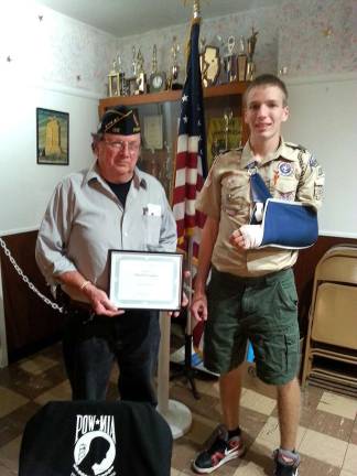 Eagle Scout Christopher Peterson of Troop 187 presents a certification of appreciation to Franklin American Legion Post 132 Commander John Kopcso for the Legion's recent hosting of Christopher's Eagle Scout Court of Honor.