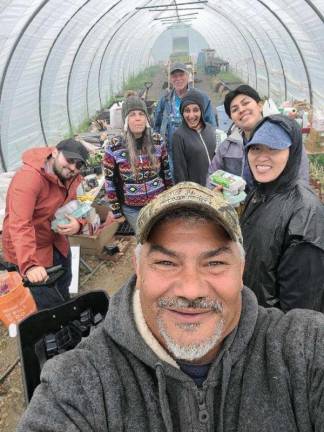The year school kids got a taste of local Michaeline Mann (in colorful fleece) and Vincent Mann (front), Turtle Clan Chief of the Ramapough Lenape Nation, at their farm in Newton, NJ. They have been getting a lot of calls, because they are on the short list of historically underserved farms. Photo by Michael Mann