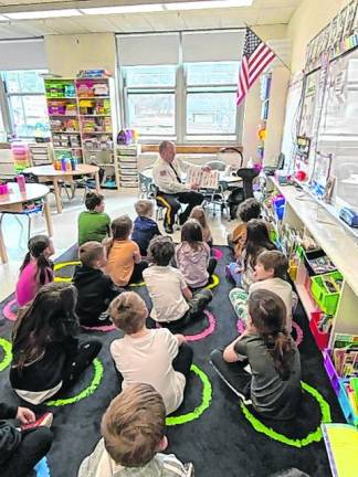 Sussex County Sheriff Michael Strada reads to first-graders at Ogdensburg Elementary School.