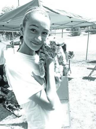 A volunteer on hand to show off the kittens available for adoption.