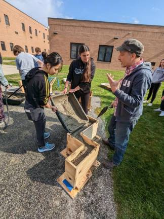 WV1 Artist Ricky Boscarino explains the poured concrete process to Pottery 1 students at Wallkill Valley Regional High School. (Photos provided)