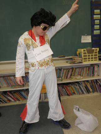 Students bring famous figures to life through 'wax musuem' Cyle Miller as Elvis Presley.