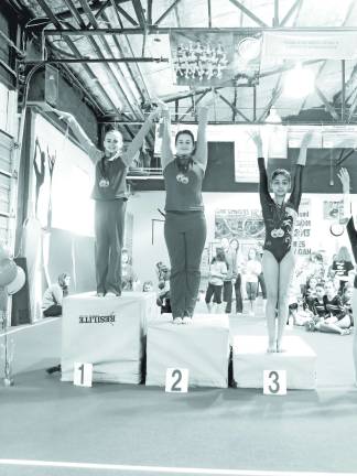 Garden Gators post successful scores in Hackettstown Reese Abrams of Sparta and teammate Morgyn Witt of Newton go 1-2 in the floor exercise.