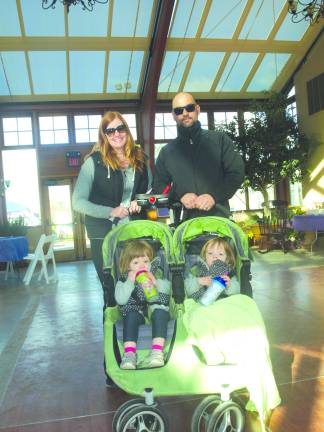 Photos by John Church Pictured from left, standing: Jessica and Jason Soehngen of Sparta, with their twin girls Olivia (left) and Amilia, who were born premature, staying warm in the Sussex County Fairgrounds Conservatory Building.