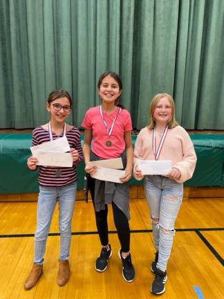 From left are Science Fair winners Maya Mianowski, second place; Adrianna Perea, first place; and Shaye Donegan, third place. All three are sixth-graders.