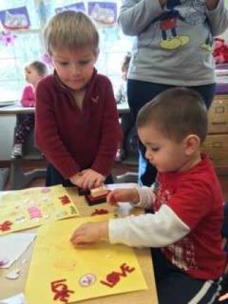 Dyland and Easton work on their valentine project.