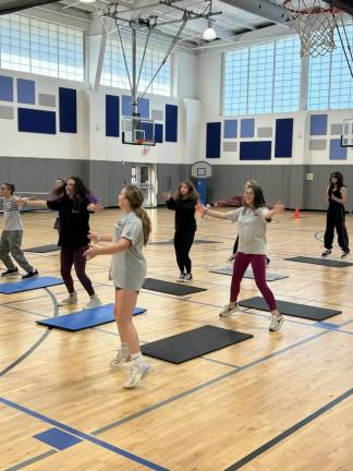 YMCA helps students get fit Y2 Students participate in a group exercise class.
