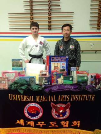 Toys for Sussex County children were donated to Project Self Sufficiency, by Universal Martial Arts, Inc.,Grandmaster Kim of Lafayette. Shown pictured are Kim and black belt John Fernandes.