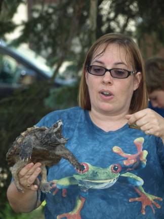 The day the snake came to the library Dawn Masino, with Rizzo' Reptile Discovery, explains the feeding habits of an alligator snapping turtle.