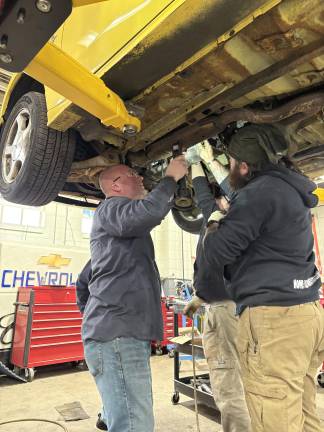 From classroom to career <b>Jason Fruge</b>, Sussex County Community College’s dean of technical occupations, and students repair a vehicle. (Photos by Bryan Fumagalli)