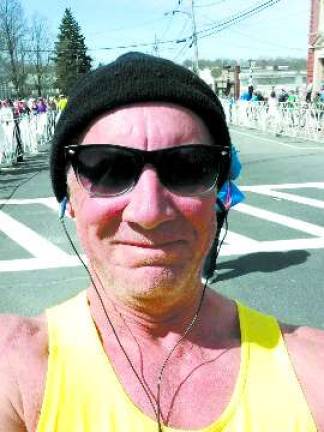 Karl Fenske snaps a photot while running the Boston Marathon.