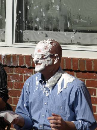 Pies on Pi Day Ogdensburg School Superintendent/Principal Tim Nicinski takes a direct hit from Lily Marino. Photo by John Church