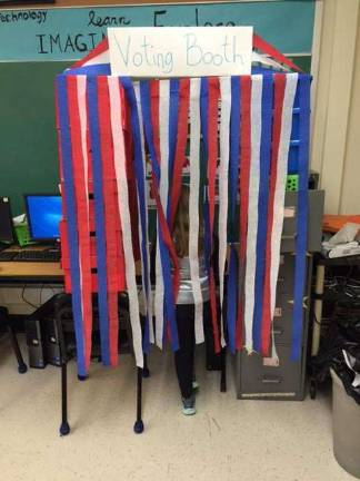 Franklin students plan fruit election A student casting her vote in the voting booth.