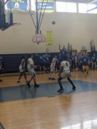 Teacher Josh Bennett dominates in the staff versus students basketball game.