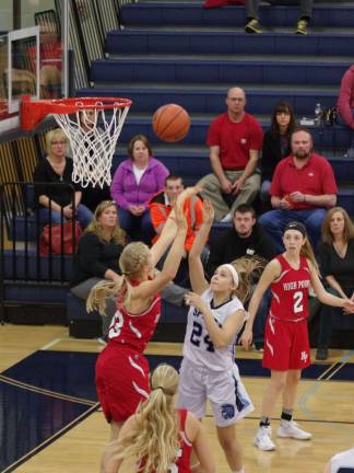 Sparta's Amanda Johnson (24) tosses the ball towards the hoop. Johnson scored five points and grabbed one rebound.