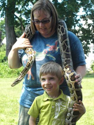 The day the snake came to the library Dawn Masino with Rizzo's Reptile Discovery lets Zachary Zampella, 5, of Ogdensburg pet the Burmese python.