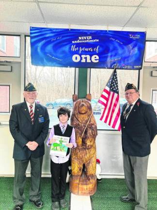 American Legion members Robert Caggiano, left, and John Kopcso pose with Alex Martinez of Ogdensburg Elementary School.