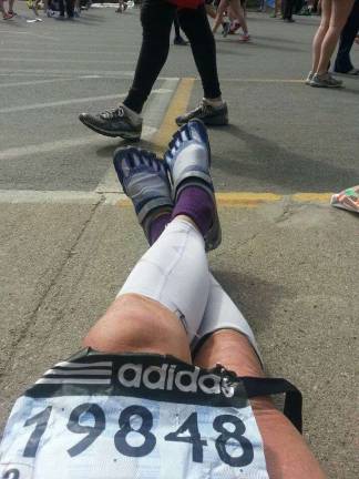 Photo by Karl Fenske Karl snaps a photo of his sneakers before running the Boston Marathon in 2013.