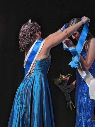 Miss Lafayette is Queen of the Fair <b>2024 Queen of the Fair </b>Chaya Ortega, left, places the sash on <b>2025 Queen of the Fair </b>Sophie Schaeffner.