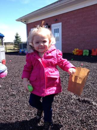 L'il KEEPers celebrate Easter, spring Emma hunts for eggson outside on the playground.