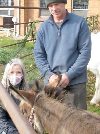 Elizabeth Neillands of Pond Hollow Farm poses with two of her friends, including her donkey, Belle, at the live nativity. Neillands also brought two goats, a Welsh pony, and her Scottie dog, Hattie (Photo by Janet Redyke)