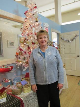 Vicki Kopacka stands by What in the World's Christmas Tree. She and her husband own the business which features Fair Trade handcrafts and foods.