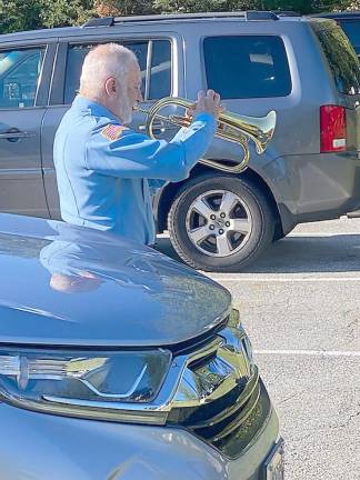 Bob Caggiano, a former member of the Air Force and current member of Bugles Across America, welcomed attendees by playing Wide Blue Yonder and other songs from all of the branches of the armed forces. He performed Taps during the ceremony. (Photo by Laurie Gordon)