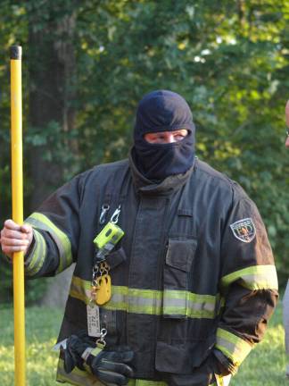 Retiring of the flag Franklin Fire Department Assistant Chief Troy Kays takes a break from the heat.