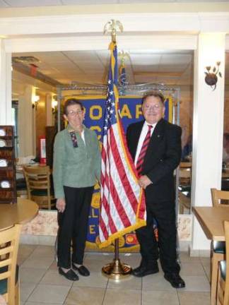 Wallkill Valley Regional High School Superintendent Bob Walker presents an American flag to Wallkill Valley Rotary President sharon Hosking.