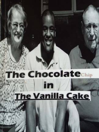 PHOTOS BY VIKTORIA-LEIGH WAGNER Martin Novak (center) is featured on the cover of his first novel, 'The Chocolate Chip in the Vanilla Cake,' between his adoptive mother Cheryl (L) and father Larry (R).