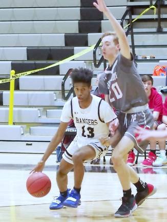 Wallkill Valley's Chris Ross dribbles the ball under tight coverage by High Point's Brandon Kubiak in the first quarter. Ross scored 8 points.