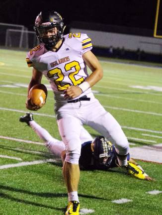 West Milford quarterback Zackary Milko runs out of bounds in the first half.
