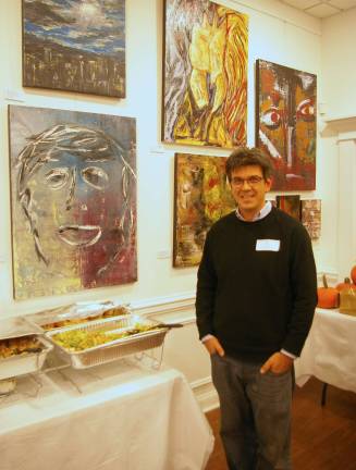 John Maione Jr. stands in front of some of his paintings. Top chef Orlando from Fratello&#xfe;&#xc4;&#xf4;s provided the accompanying feast.