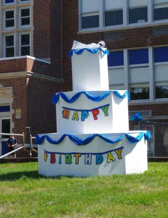 A 100th birthday cake rests on the lawn as visitors arrived at the school.