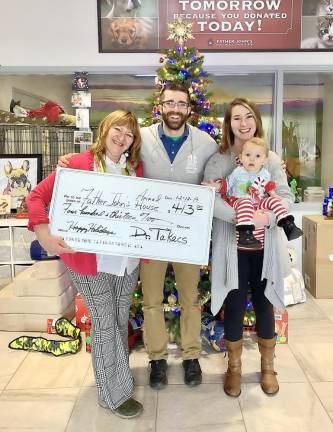 From left, Dr. M. Helena Takacs, Garret Barcheski (Shelter Director) and Brielle Slate holding Adelaide Slate.