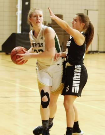 Veritas Christian's Jane Valkema handles the ball while covered by Wallkill Valley's Samantha Opilla. Valkema scored 2 points.