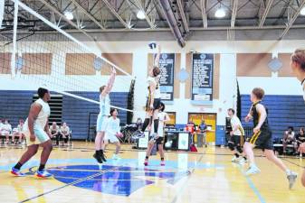 Jefferson's Raymond Bradley reaches for the ball high above the net in the volleyball match against Sparta there Thursday, April 11. The Falcons won, 25-18, 25-19. Bradley was credited with two kills and two digs. (Photos by George Leroy Hunter)