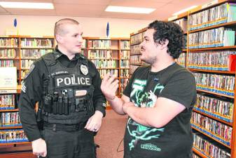 Kenneth Andujar of Franklin talks to police Sgt. Robert Vander Ploeg during a Coffee with a Cop event Thursday, March 7 at the Franklin library branch. (Photos by Maria Kovic)