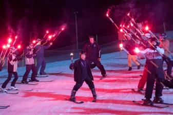 Aaron Bono, 31, of Wantage carries the torch down the mountain to light the flame for the opening ceremony of the Special Olympics New Jersey 2023 Winter Games on Feb. 6 in Vernon. (Photo courtesy of the Special Olympics)