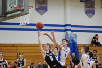 Wallkill Valley's Shawn Falk (5) tosses the ball towards the hoop while Kittatinny's Brian Plath (1) tries to block the shot in the second half. Falk scored 11 points.