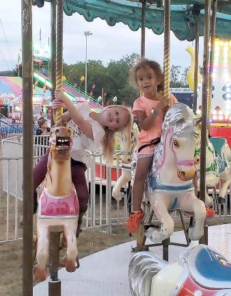 Lily and Dakota enjoyed riding the merry-go-round together