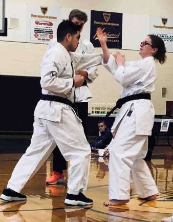 Monica McGovern countering an attack by Jose Gomez during a Self-defense demonstration at the Vernon Valley Karate Winterfest Tournament.
